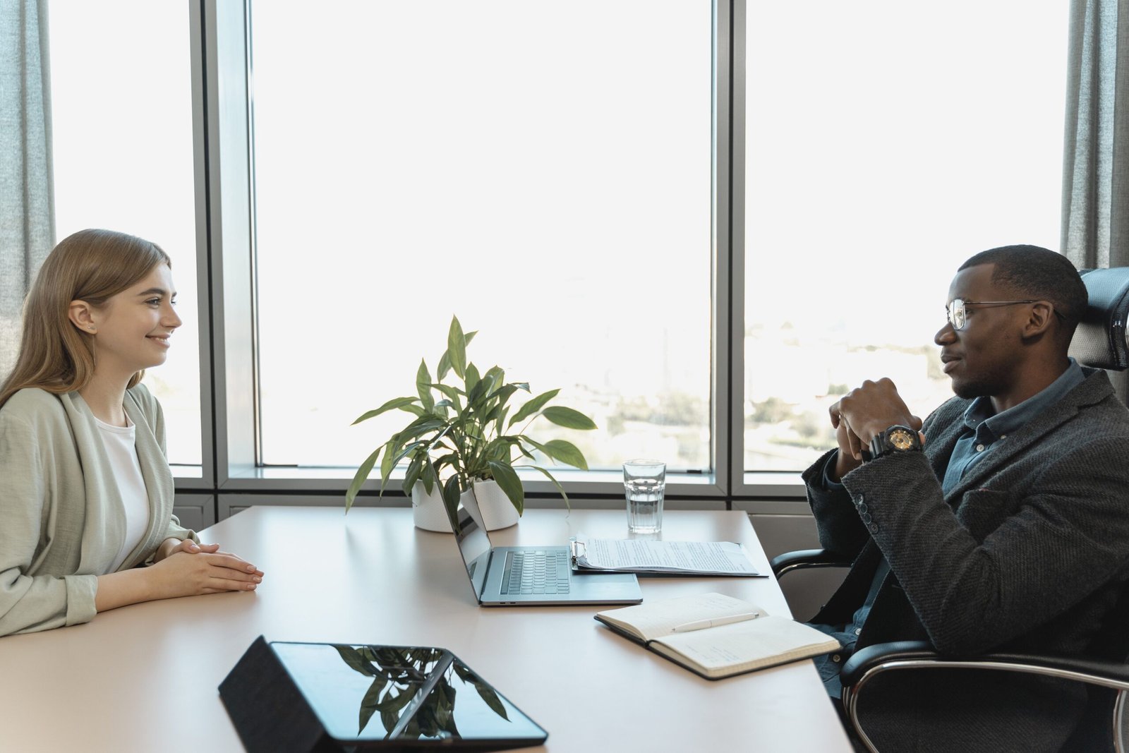 Two colleagues in conversation during a job interview in a bright, modern office