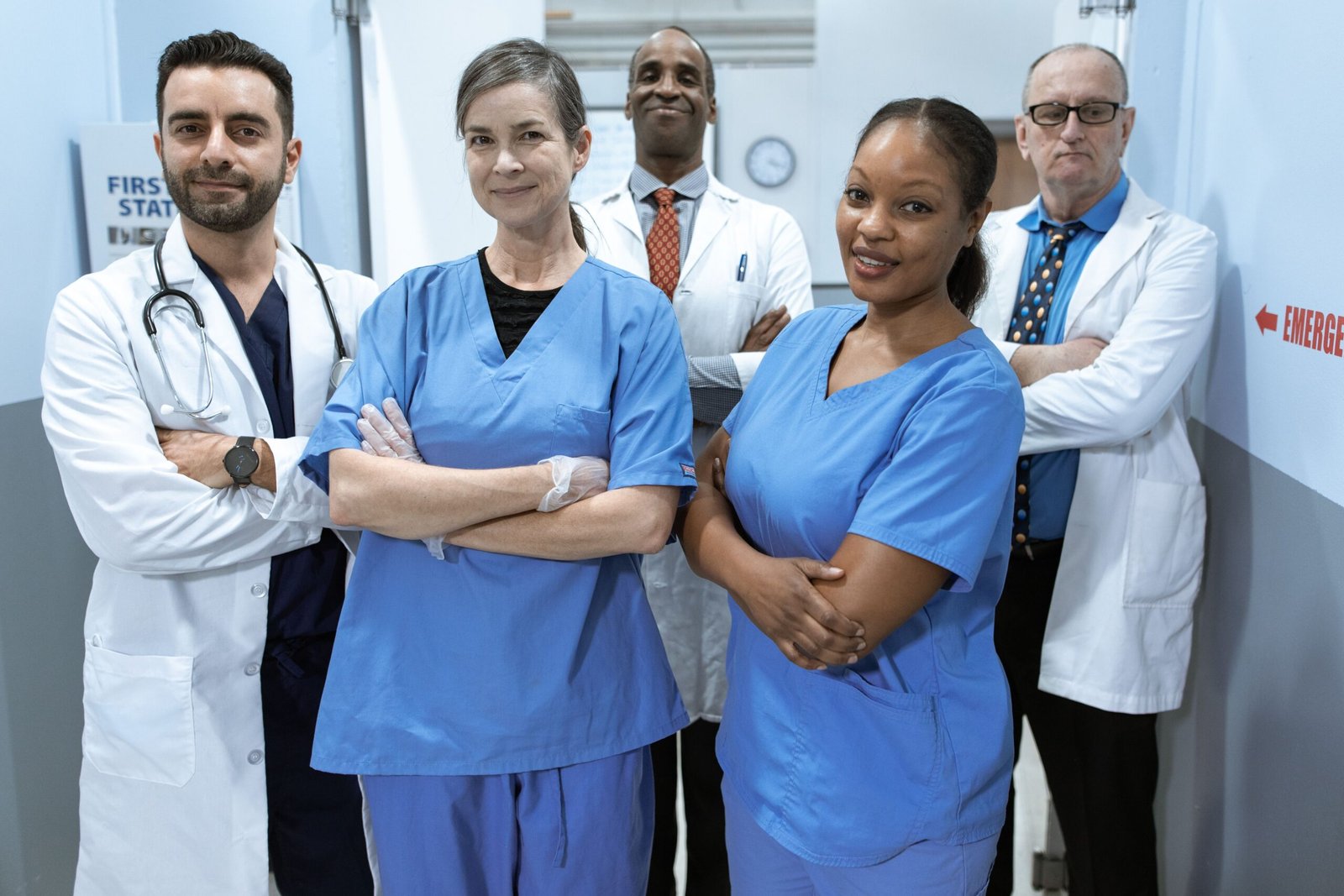 A team of healthcare workers, including nurses, standing together in a hospital setting